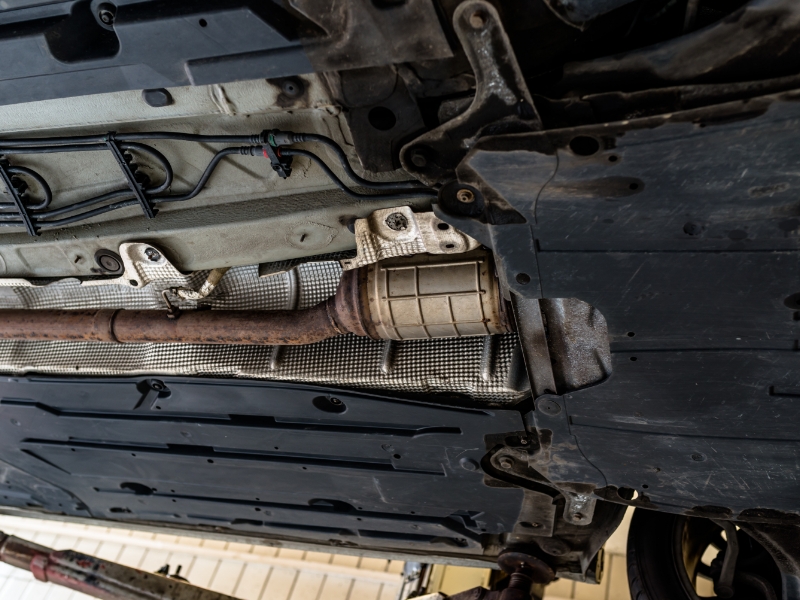 The exhaust system of a vechile shown from underneath