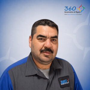 Automotive technician portrait in branded uniform