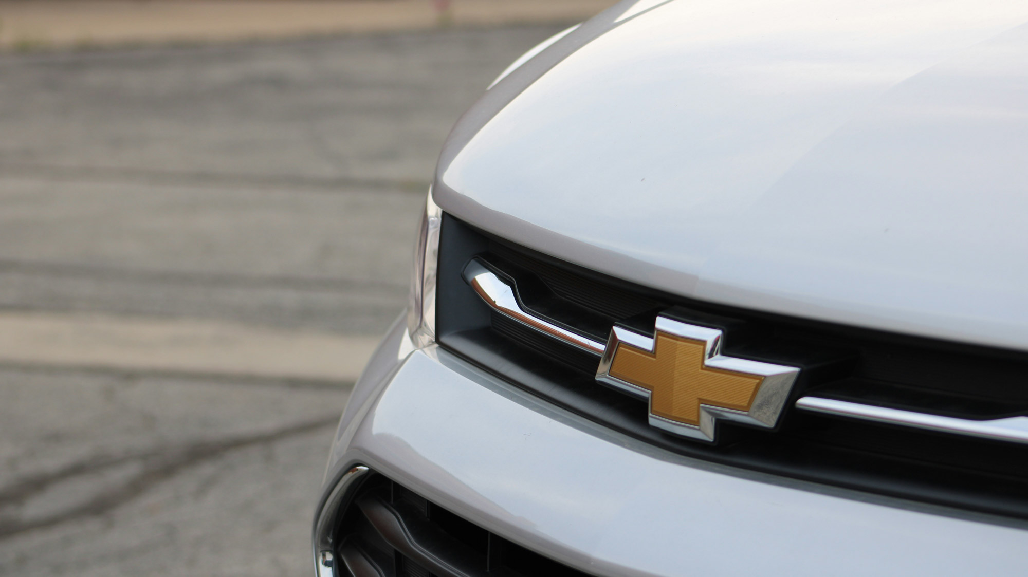 Close-up of Chevrolet logo on white car grille