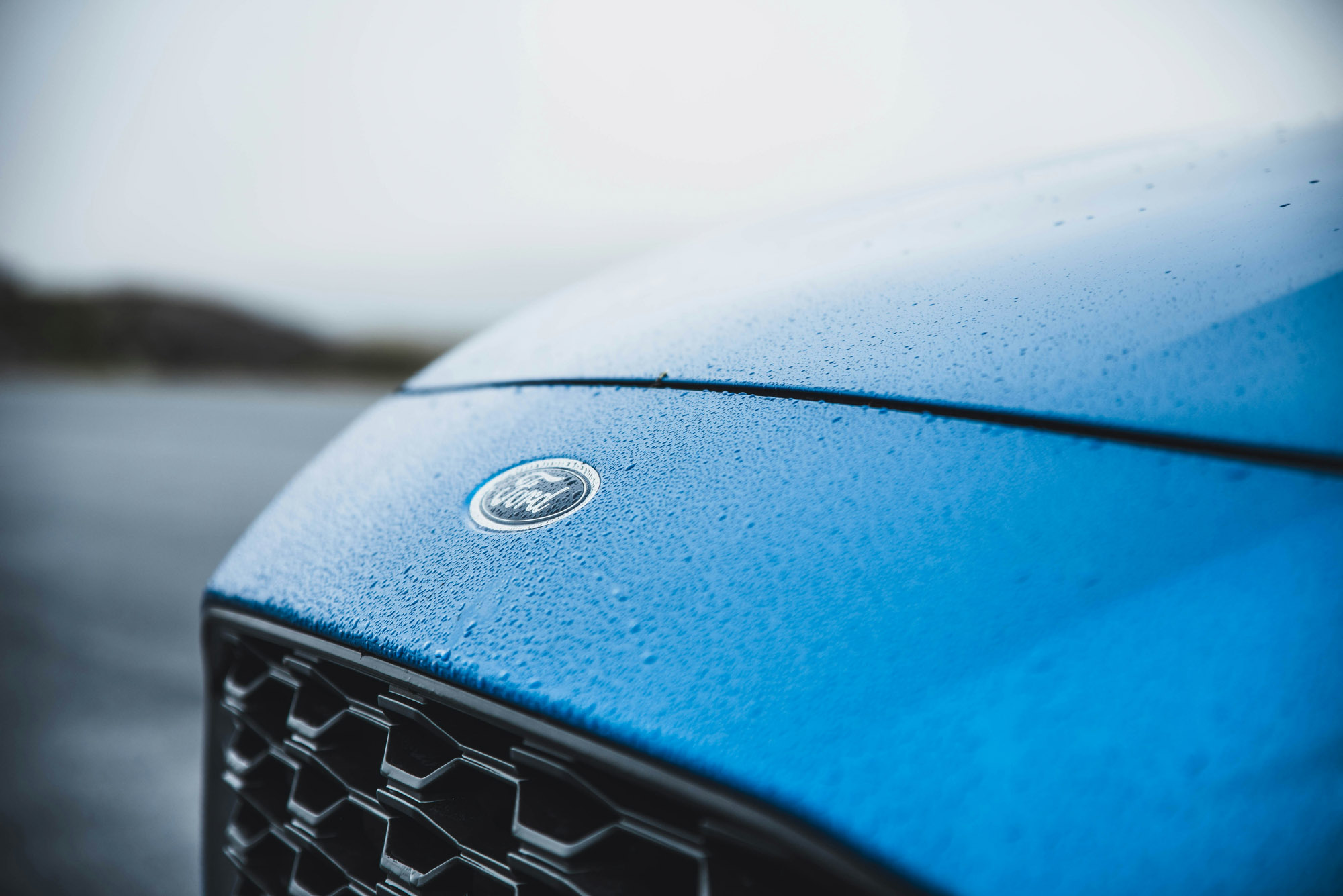 Blue Ford hood with raindrops and emblem