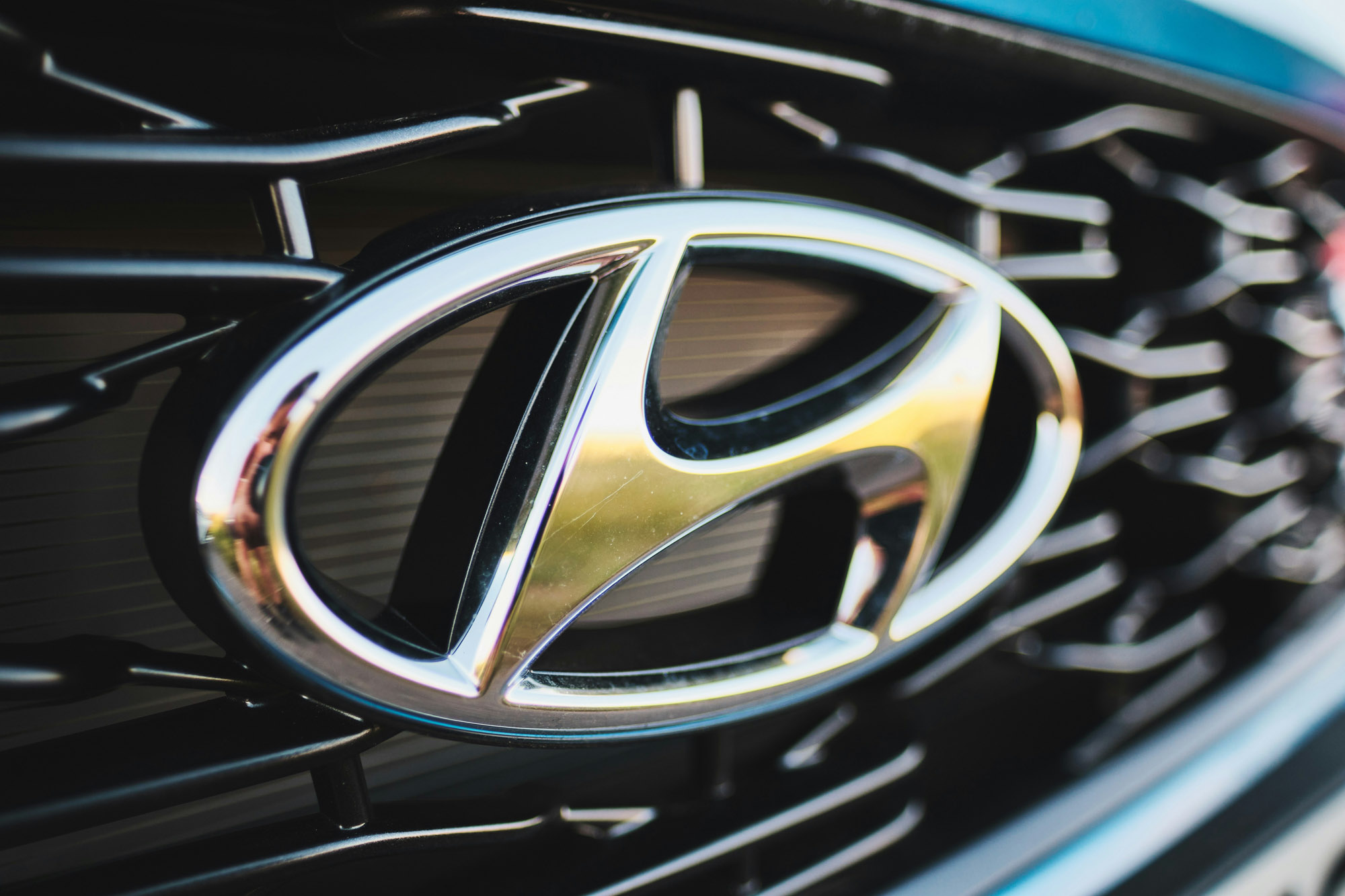 Close-up of Hyundai logo on car grille