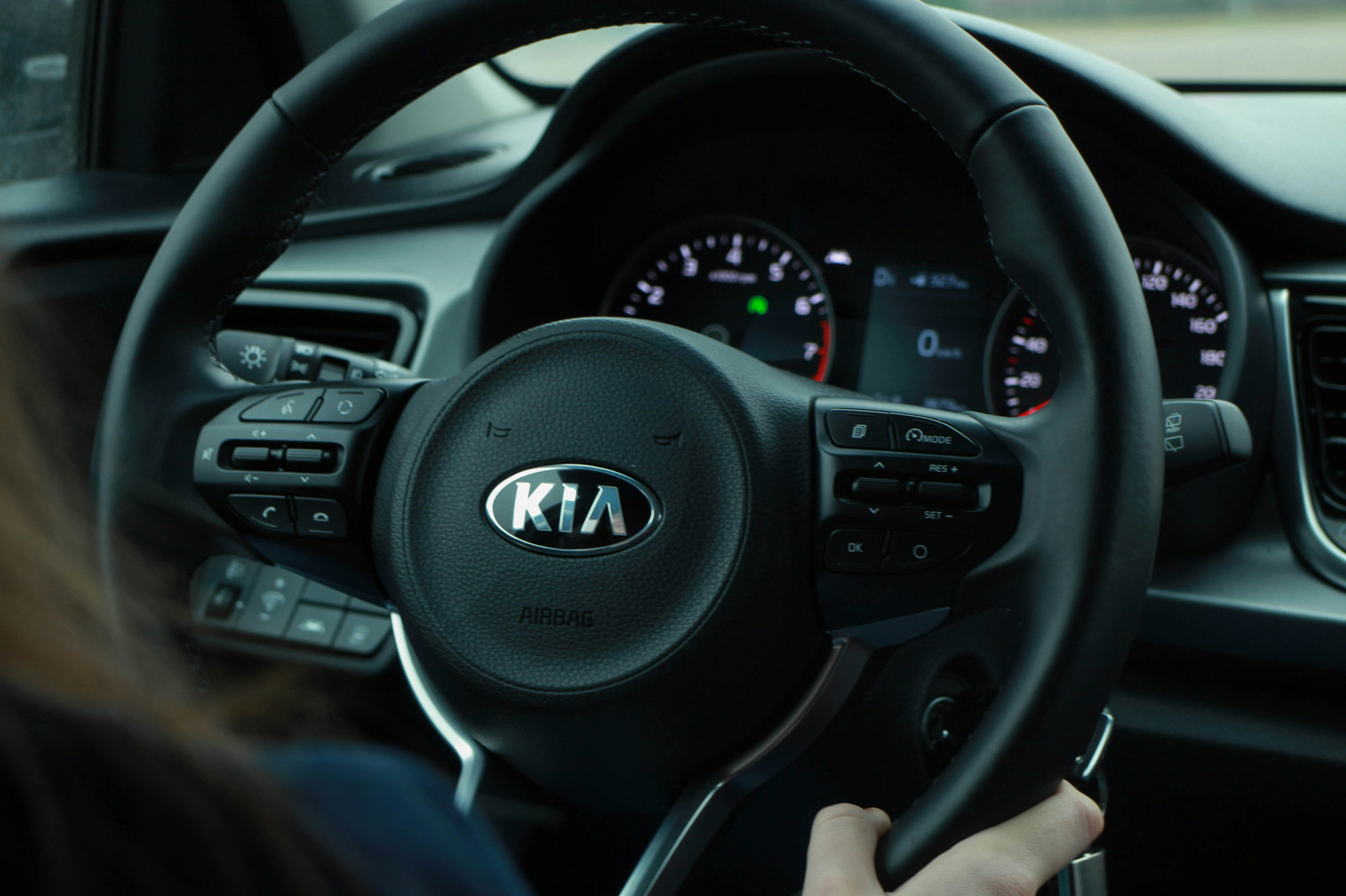 Kia steering wheel and dashboard interior view