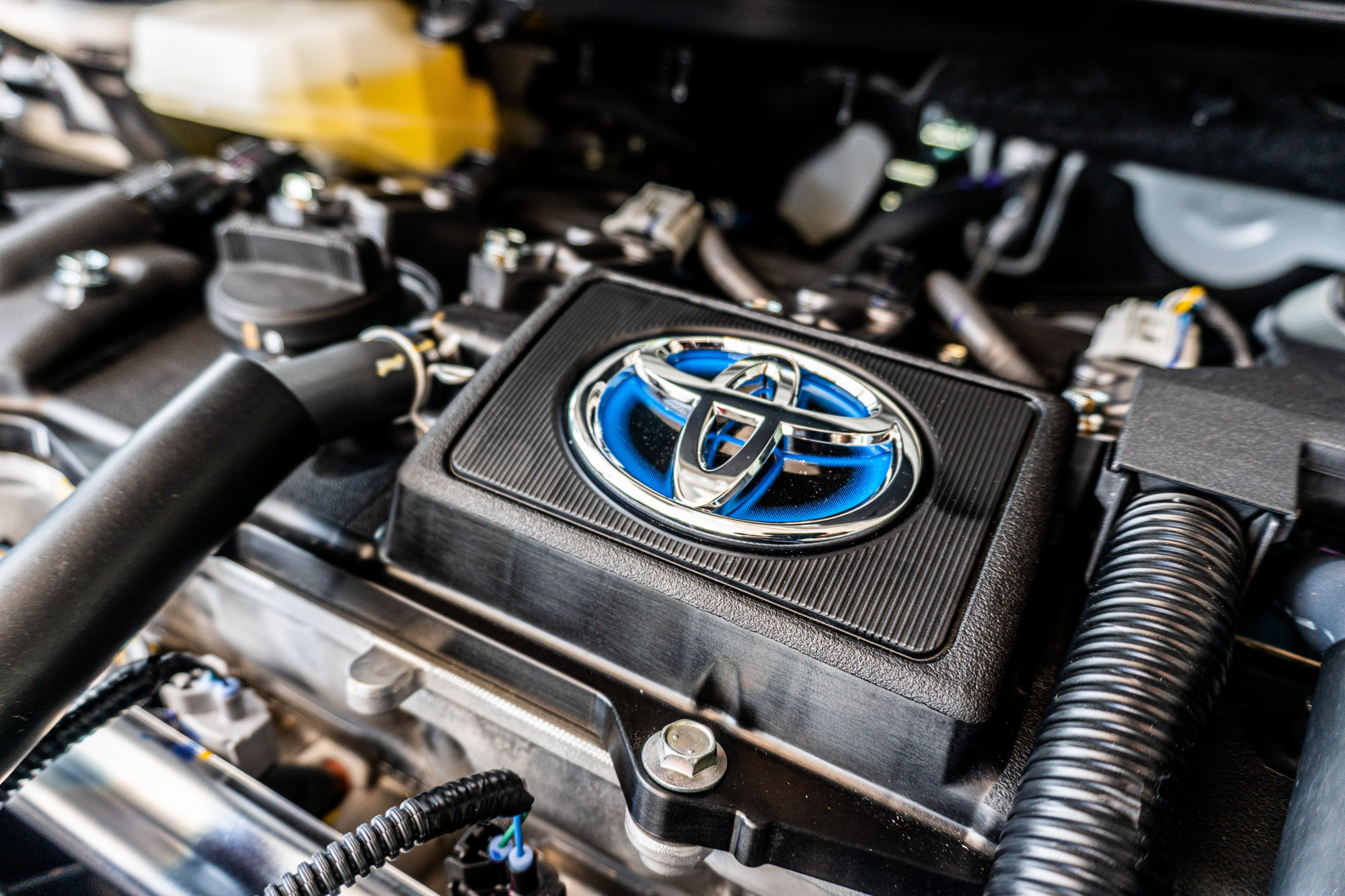 Toyota logo on hybrid car engine cover